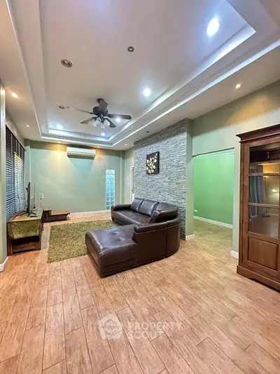 Spacious living room with modern design and cozy leather sofa