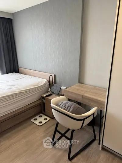 Modern bedroom with stylish furniture and cozy workspace in a contemporary apartment.