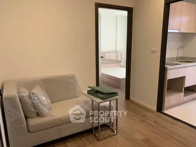 Modern apartment interior with cozy living room and sleek kitchen design.