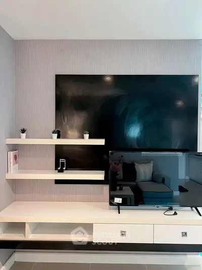 Modern living room with sleek TV setup and stylish shelving