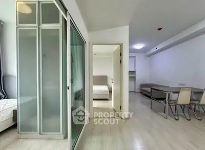 Modern apartment interior with sliding glass doors and minimalist furniture