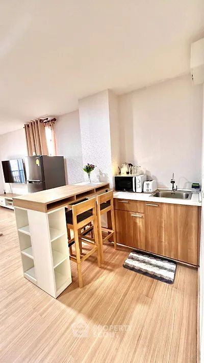 Modern kitchen with wooden cabinets and breakfast bar in cozy apartment