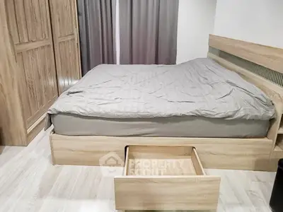 Spacious bedroom with modern wooden furniture and ample storage space.