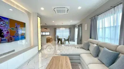 Spacious modern living room with elegant decor and open dining area, perfect for family gatherings.