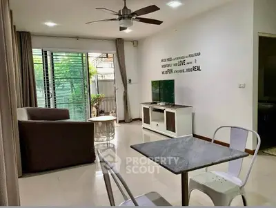 Modern living room with stylish furniture and natural light, perfect for relaxation and entertainment.