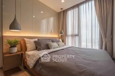 Luxurious bedroom with modern decor and large windows for natural light.