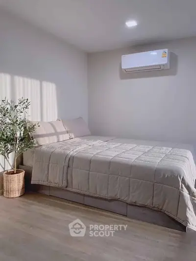Cozy bedroom with modern air conditioning and stylish decor, perfect for relaxation and comfort.