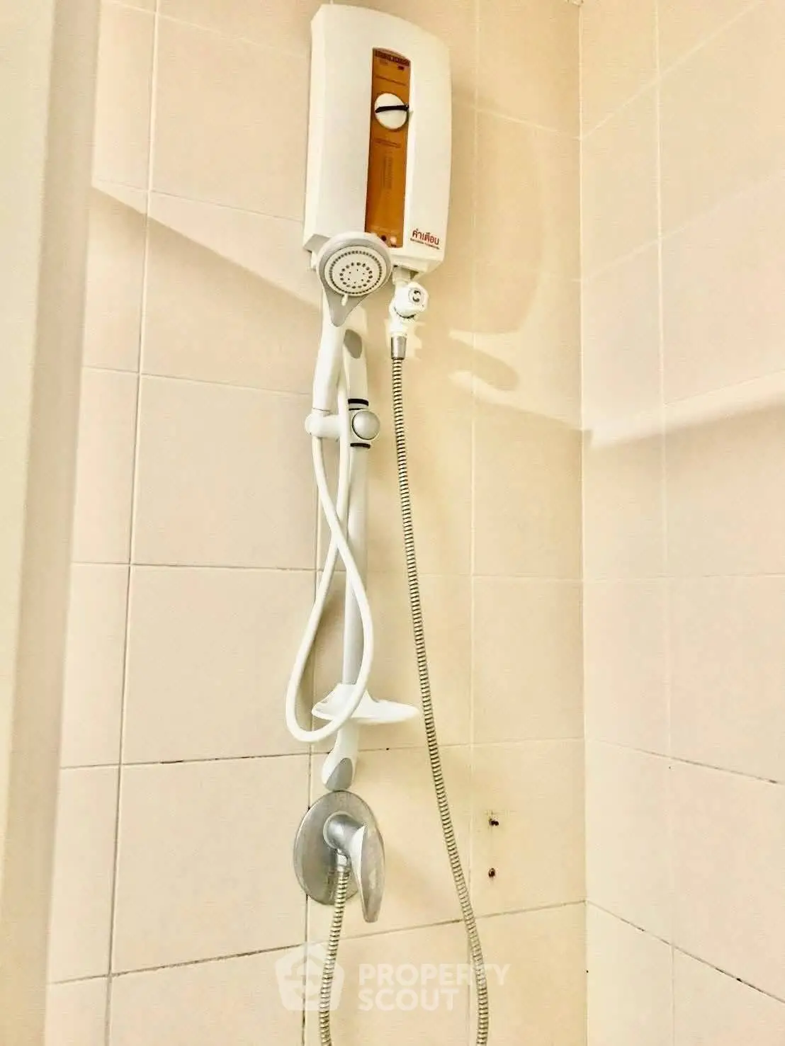 Modern bathroom shower with water heater in tiled enclosure