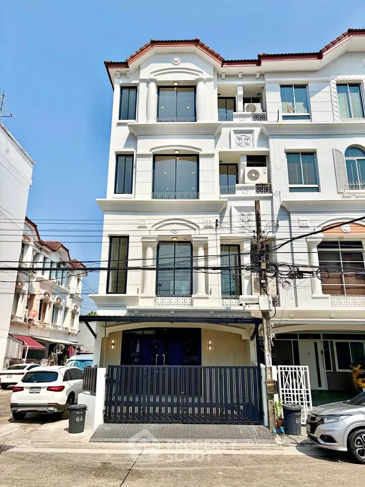 Elegant multi-story townhouse with modern facade and large windows in a vibrant neighborhood.