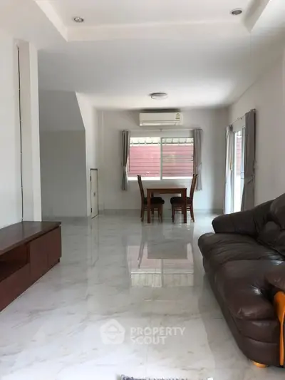 Spacious living room with modern furniture and large windows for natural light.