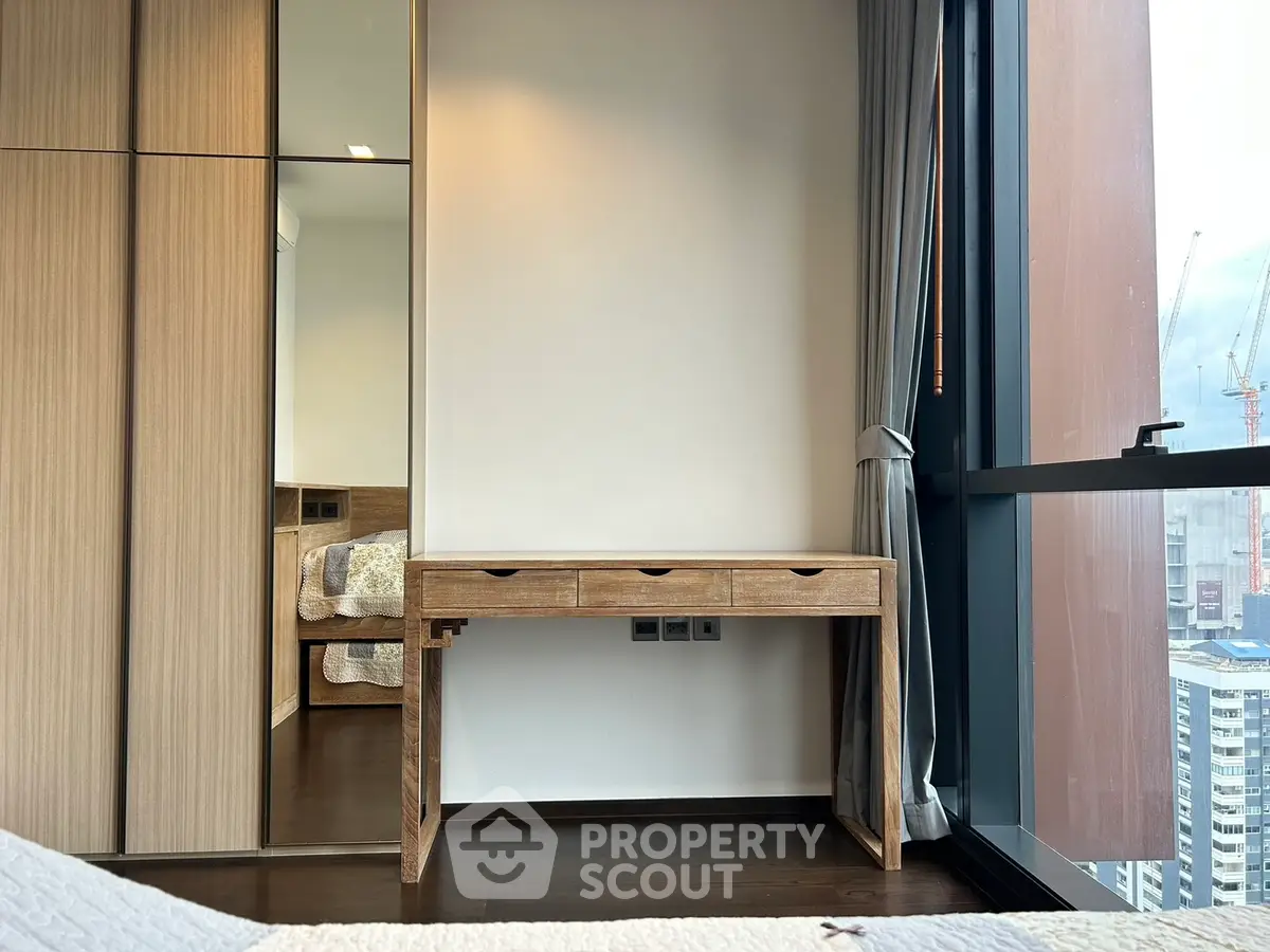 Modern bedroom with wooden furniture and city view window