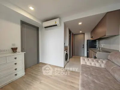 Modern apartment interior with open kitchen and washing machine