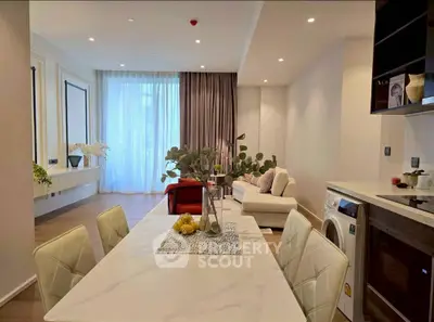 Modern open-plan living and dining area with elegant decor and natural light