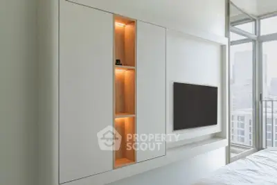 Modern living room with built-in shelving and city view from large windows.