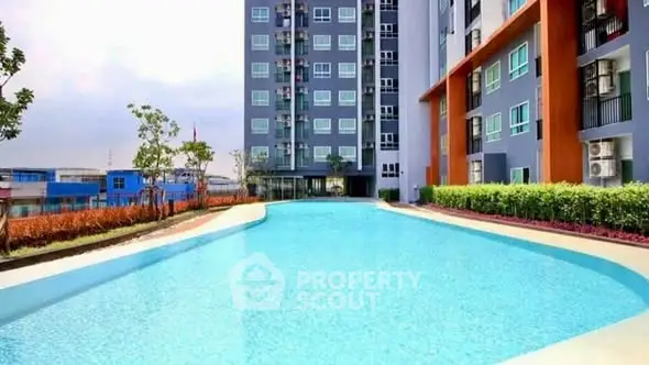 Modern apartment building with a stunning outdoor pool and landscaped surroundings.