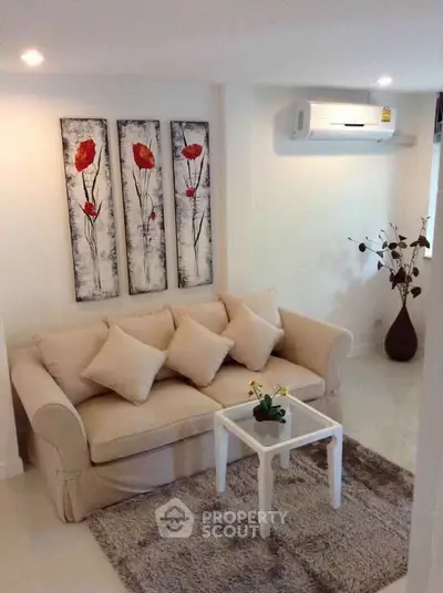 Cozy living room with elegant beige sofa and modern art decor