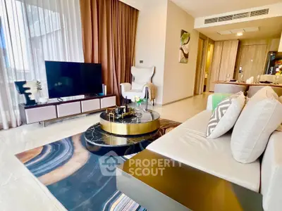 Luxurious modern living room with elegant decor and large TV, perfect for relaxation and entertainment.