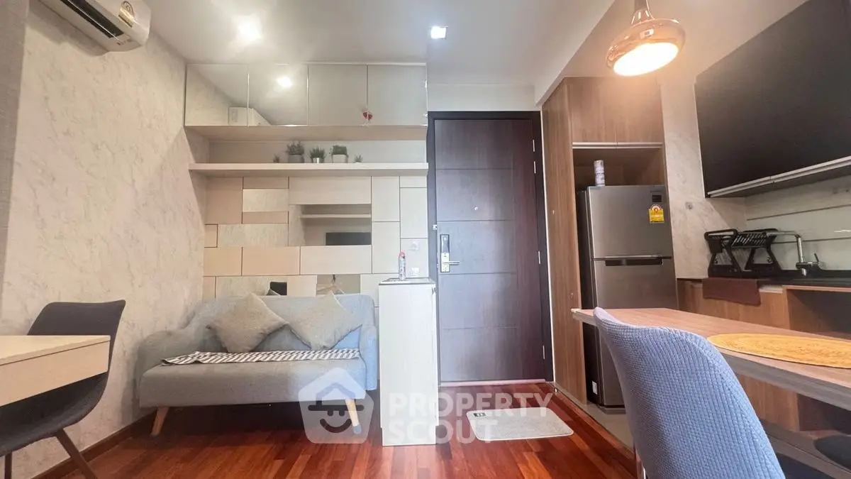 Modern living room with stylish decor and compact kitchen area