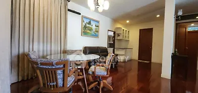 Spacious living room with elegant wooden flooring and cozy seating area