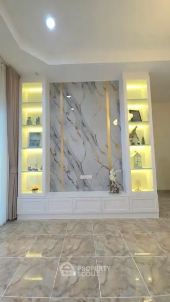 Luxurious living room with marble accent wall and elegant built-in shelves, perfect for modern home decor.