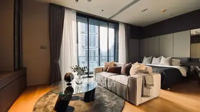 Luxurious modern living room with floor-to-ceiling windows and elegant decor in a high-rise apartment.