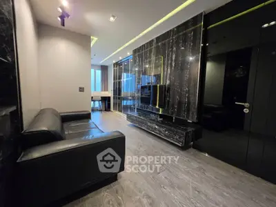 Luxurious modern living room with sleek black marble accents and stylish furnishings.