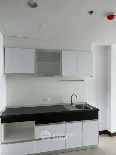 Modern minimalist kitchen with sleek cabinetry and stainless steel sink