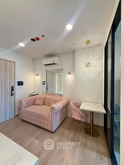 Chic modern living room with plush pink sofa and elegant lighting, perfect for stylish urban living.