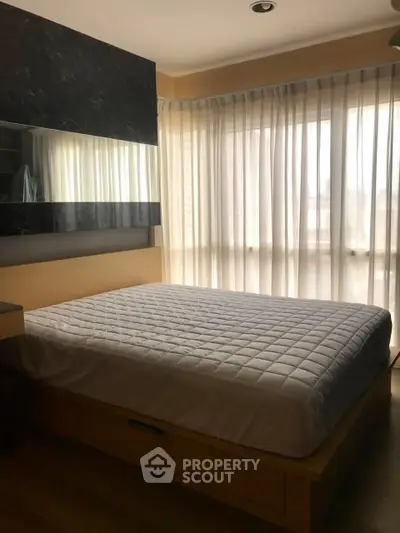 Cozy bedroom with large windows and modern decor