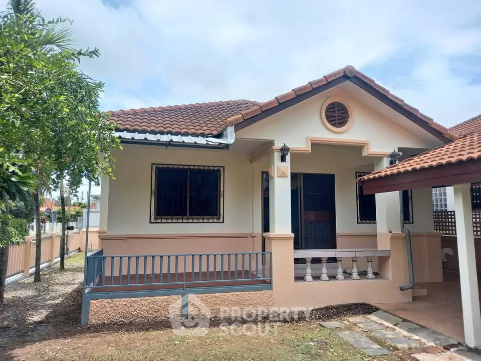 Charming single-story house with tiled roof and inviting front porch in a serene neighborhood.