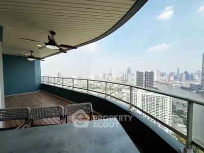 Stunning high-rise balcony with panoramic city and river views, perfect for relaxation and entertaining.