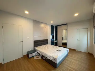 Modern bedroom with stylish decor and ample natural light