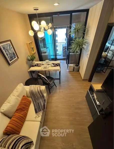 Stylish living room with modern decor and balcony access, perfect for urban living.