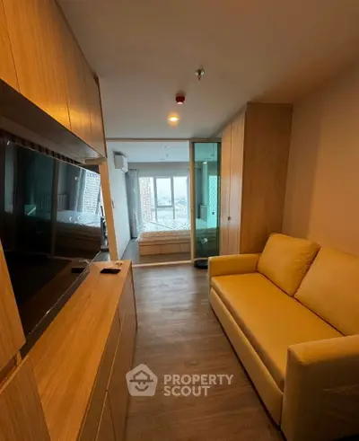 Cozy studio apartment with modern furnishings and large window view
