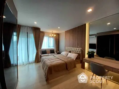 Spacious bedroom with modern design, featuring a large bed with stylish headboard, ambient lighting, and a cozy dining area.