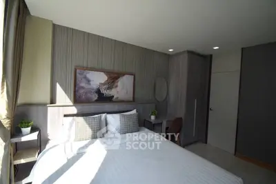 Modern bedroom with stylish decor and natural light in a contemporary apartment.
