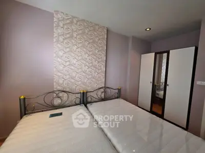 Spacious bedroom with stylish decor and ample storage in modern real estate property.