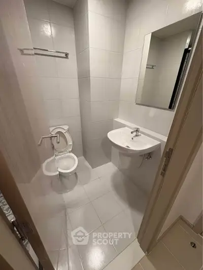 Modern minimalist bathroom with sleek fixtures and neutral tiles