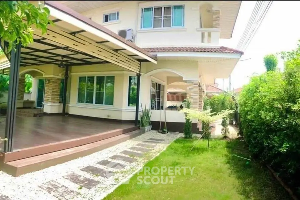 Charming two-story house with lush garden and spacious patio, perfect for family living.