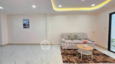 Spacious modern living room with elegant lighting and cozy seating area.