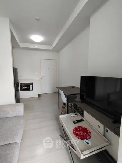 Modern living room with sleek furniture and open kitchen layout