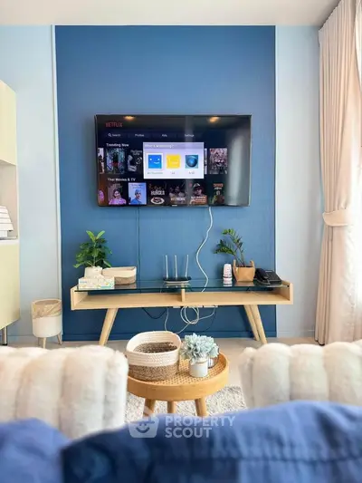 Modern living room with wall-mounted TV and stylish decor