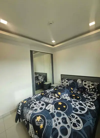 Modern bedroom with stylish bedding and mirrored closet doors