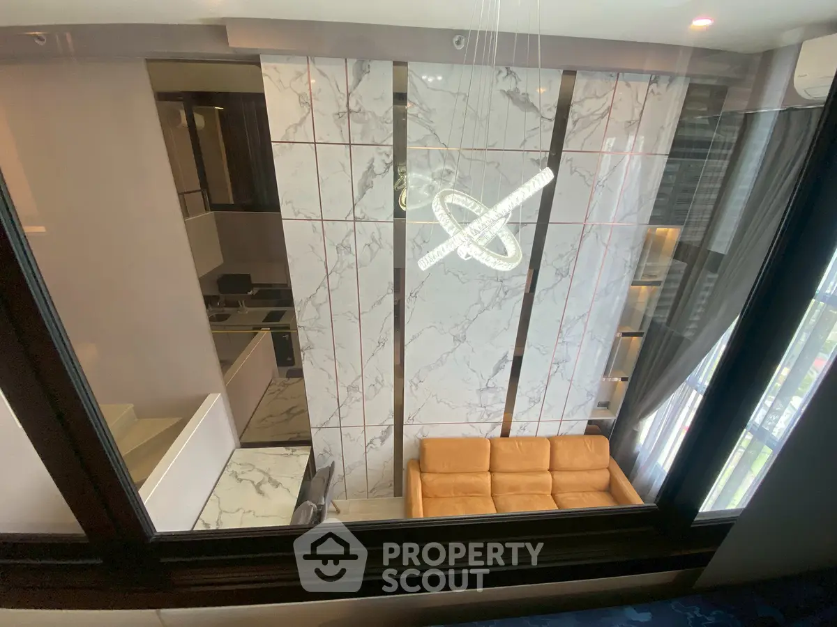 Luxurious modern living room with marble walls and stylish chandelier