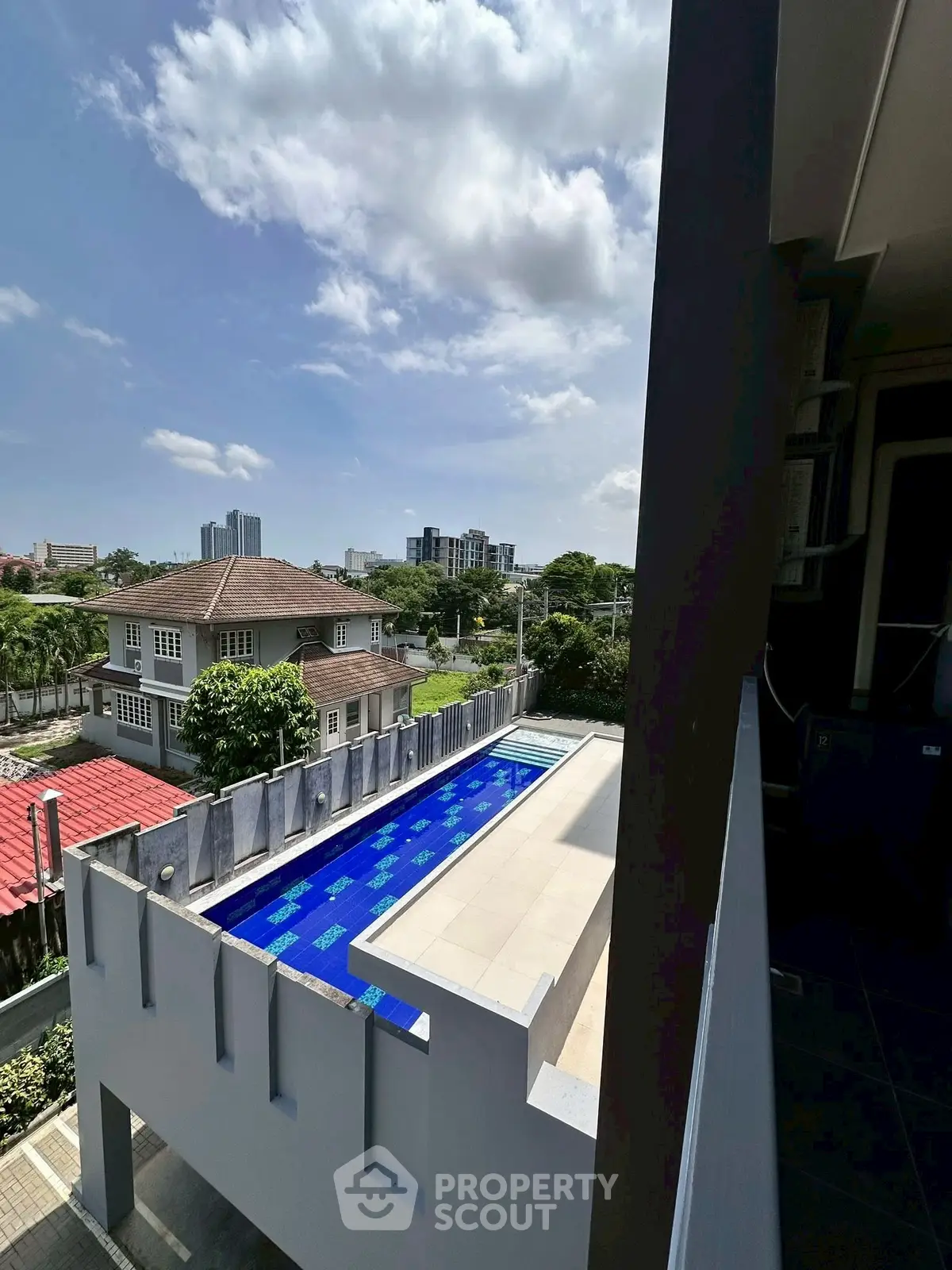 Stunning rooftop pool with city view in a modern residential area.