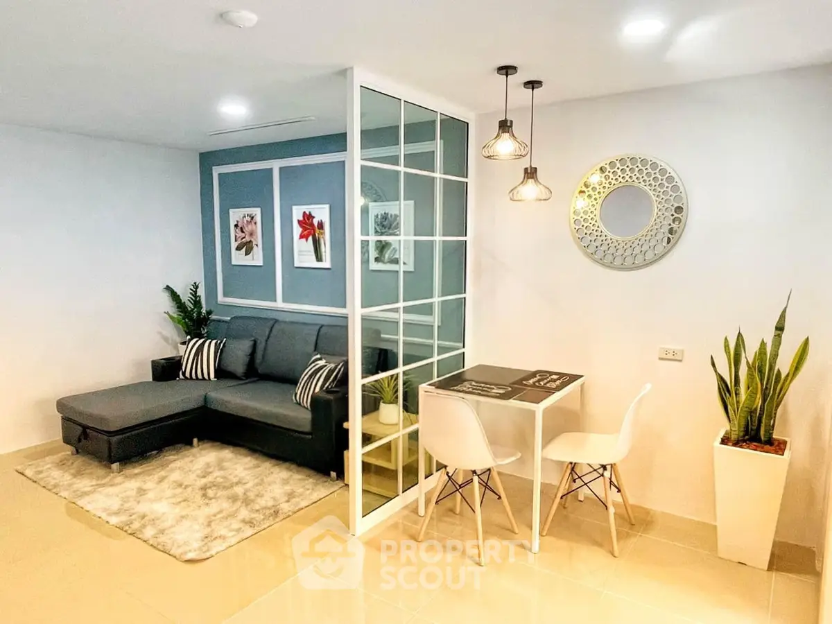 Modern living room with stylish decor, sectional sofa, and dining area in open layout apartment.