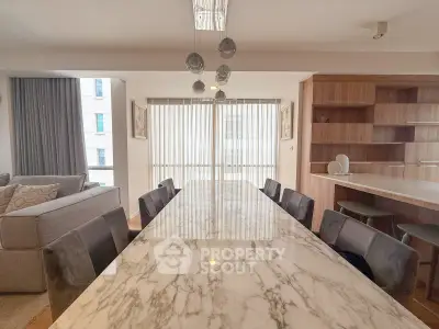 Luxurious dining area with marble table and modern decor in a spacious apartment.
