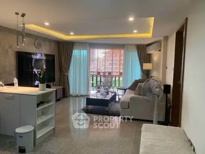 Spacious modern living room with elegant decor and large windows opening to a balcony.