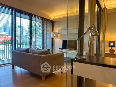 Modern living room with city view, featuring stylish furniture and large windows.