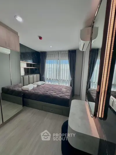 Modern bedroom with stylish decor and large window for natural light